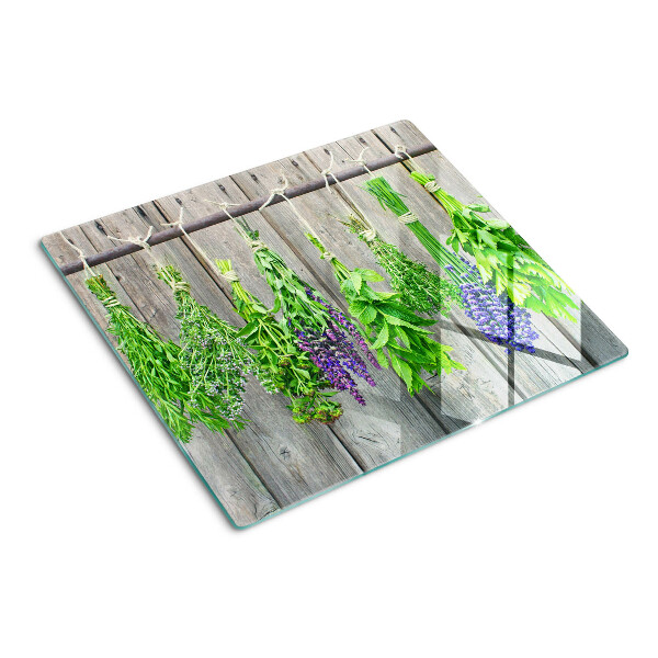 Tábua para cozinha Ervas secas em um fundo de madeira