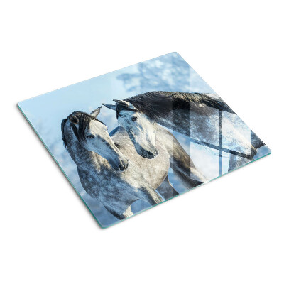 Tábua para corte Cavalos em uma paisagem de inverno