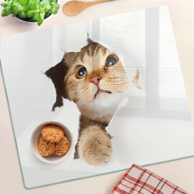 Tábua para corte Um gato olhando através de um buraco na parede