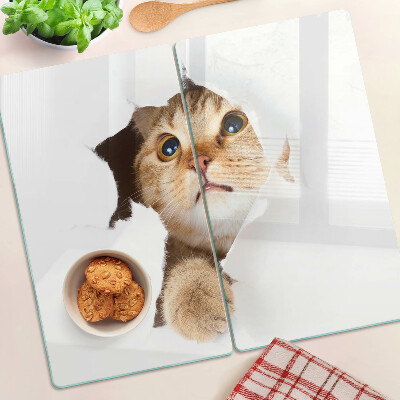 Tábua para corte Um gato olhando através de um buraco na parede