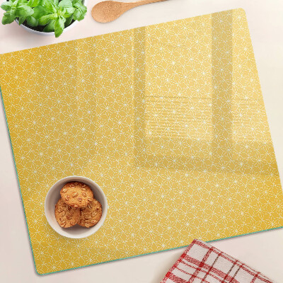 Tábua para corte Flor da vida em um fundo amarelo