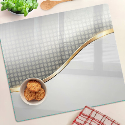 Tábua para corte Uma onda dourada sobre um fundo de pontos