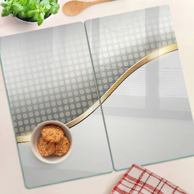 Tábua para corte Uma onda dourada sobre um fundo de pontos