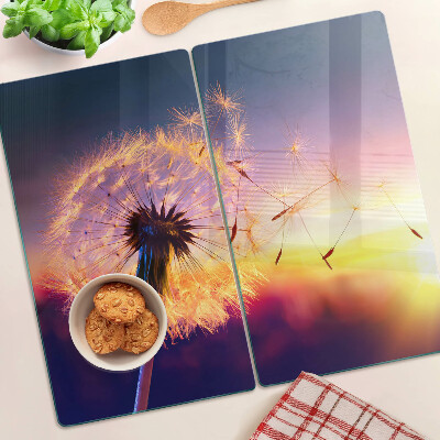 Tábua para cozinha Dentes-de-leão contra o fundo do pôr do sol