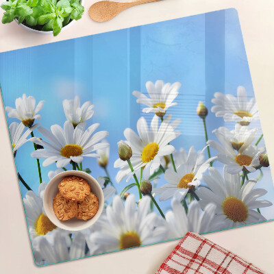 Tábua para corte Flores de margarida em um fundo azul