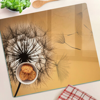 Tábua para corte Dentes-de-leão contra o fundo do pôr do sol