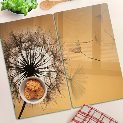 Tábua para corte Dentes-de-leão contra o fundo do pôr do sol