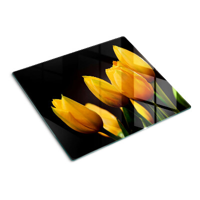 Tábua para corte Tulipas amarelas em um fundo preto