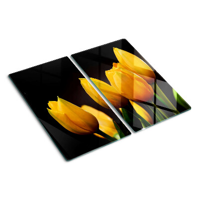Tábua para corte Tulipas amarelas em um fundo preto