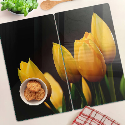 Tábua para corte Tulipas amarelas em um fundo preto