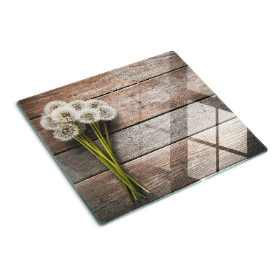 Tábua para corte Flores de dente-de-leão em um fundo de madeira