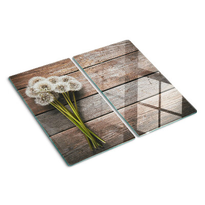 Tábua para corte Flores de dente-de-leão em um fundo de madeira