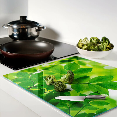 Tábua para cozinha Folhas em um fundo verde