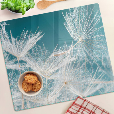 Tábua para corte Dente-de-leão em um fundo azul