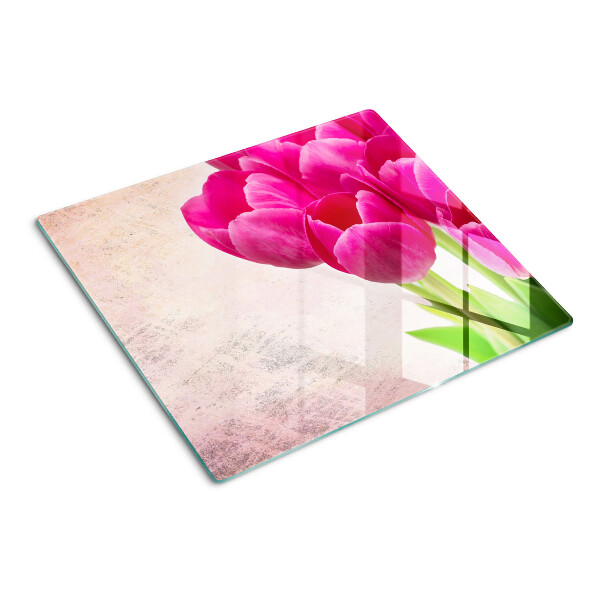 Tábua para corte Flores de tulipa em um fundo rosa
