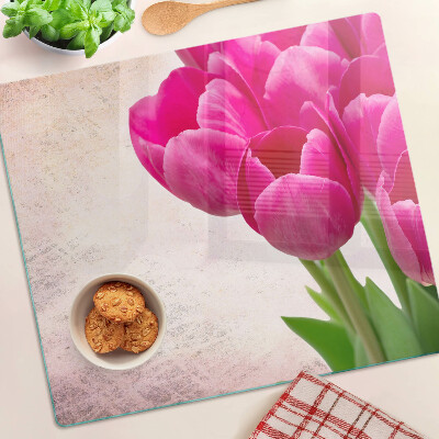 Tábua para corte Flores de tulipa em um fundo rosa
