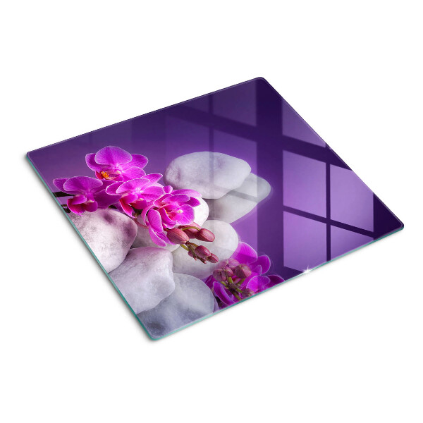 Tábua para cozinha Flores de orquídea em um fundo de pedras