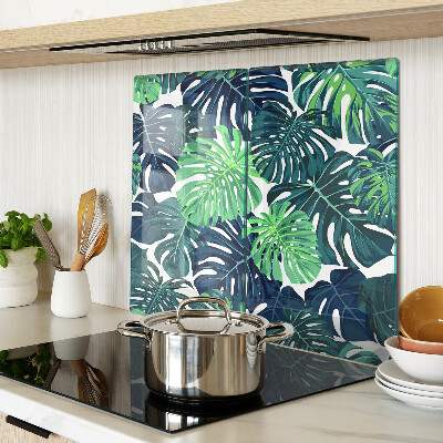 Tábua para corte Folhas de Monstera em um fundo tropical