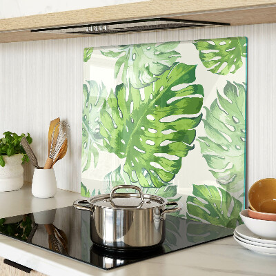 Tábua para corte Folhas de Monstera em um fundo claro