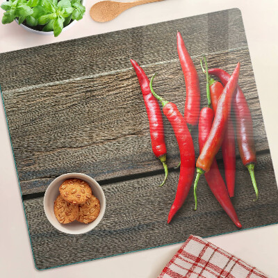 Tábua para cozinha Pimentas em um fundo de madeira
