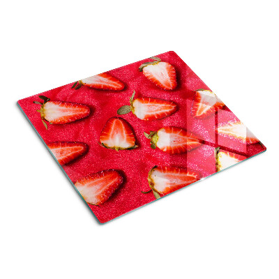 Tábua para corte Morangos em um fundo rosa