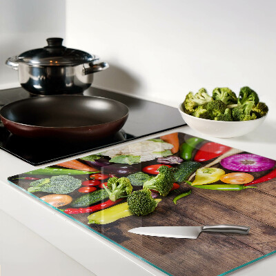 Tábua para cozinha Legumes em um fundo de madeira