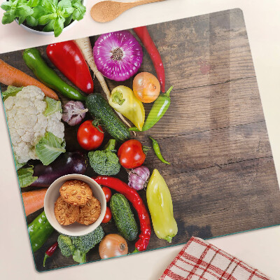 Tábua para cozinha Legumes em um fundo de madeira