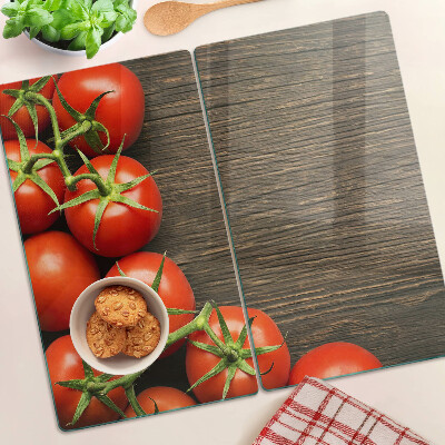 Tábua para cozinha Tomates em um fundo de madeira