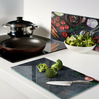 Tábua para cozinha Legumes e especiarias em um fundo escuro