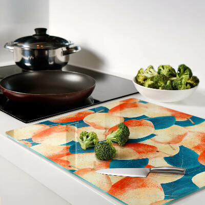 Tábua para cozinha Pêssegos contra o fundo de folhas