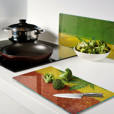 Tábua para cozinha Folha de cannabis em um fundo colorido