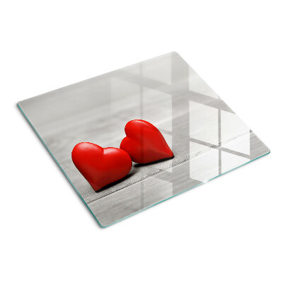 Tábua para cozinha Corações vermelhos em um fundo de madeira