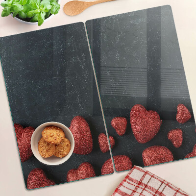 Tábua para corte Corações vermelhos em um fundo escuro