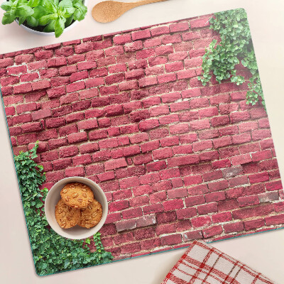 Tábua para corte Parede de tijolos com vegetação