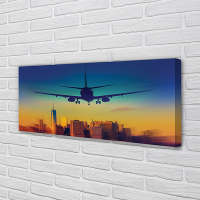 Pintura em tela Cidade nuvens avião pôr do sol