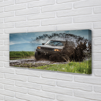 Quadro em tela Veículo off-road montanhas nuvens