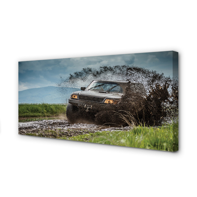 Quadro em tela Veículo off-road montanhas nuvens