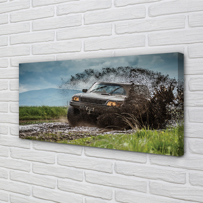 Quadro em tela Veículo off-road montanhas nuvens