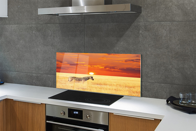 Painel de vidro Pôr do sol no campo de zebras