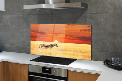 Painel de vidro Pôr do sol no campo de zebras