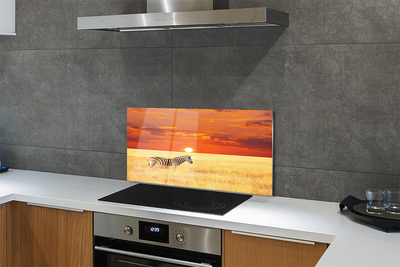 Painel de vidro Pôr do sol no campo de zebras