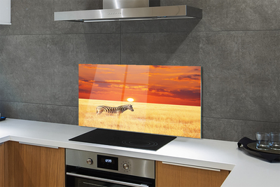 Painel de vidro Pôr do sol no campo de zebras
