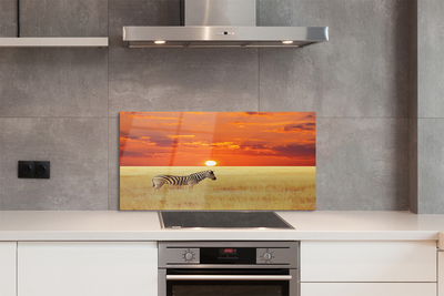 Painel de vidro Pôr do sol no campo de zebras