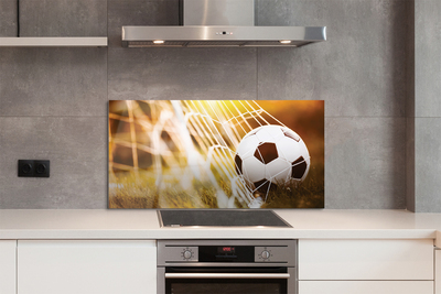 Painel de vidro Bola amarela em fundo de grama