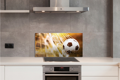 Painel de vidro Bola amarela em fundo de grama