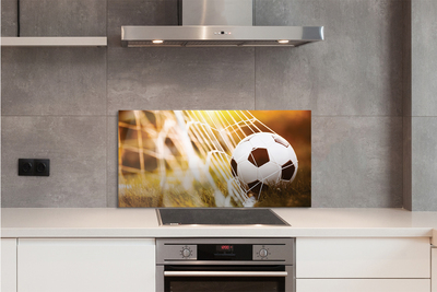 Painel de vidro Bola amarela em fundo de grama