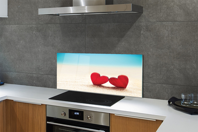 Painel de vidro Corações de areia vermelha do mar