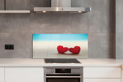 Painel de vidro Corações de areia vermelha do mar