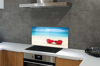 Painel de vidro Corações de areia vermelha do mar