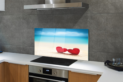 Painel de vidro Corações de areia vermelha do mar